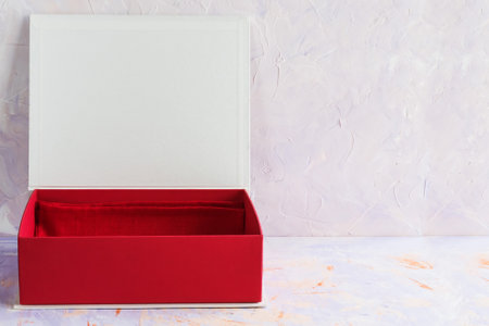 Open gift box in red color on a decorative backgroundの写真素材
