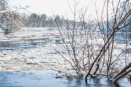 Spring melting of ice and snow on the river on a sunny day