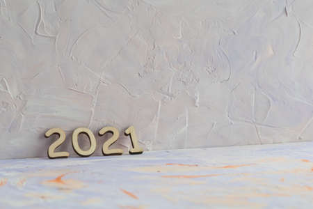 The date 2021 is laid out of wooden numbers on a decorative light backgroundの写真素材