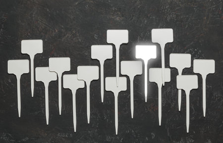 Collage of small white plastic signs on a dark background