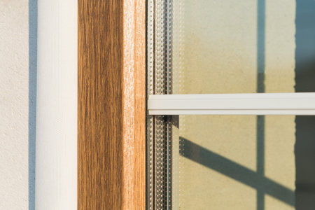 Laminated plastic window with white partitions inside a double-glazed window in a new building under...