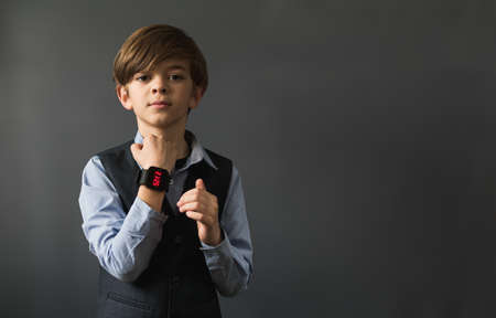Portrait image of a small boy with a wrist electronic watchの写真素材