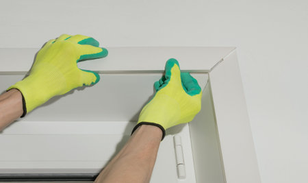 The master makes plastic slopes for windows from insulated panels of white color