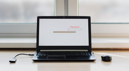 The included laptop of black color for work stands near the window