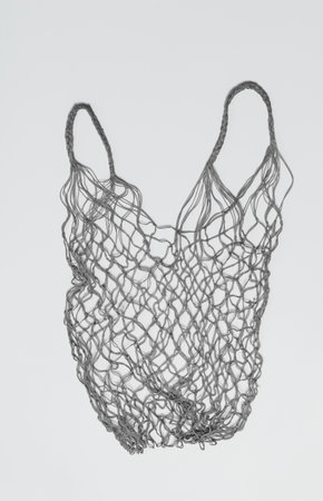 Old wicker food net in gray color on a light background