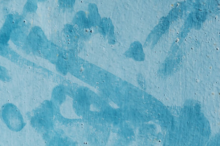 Fingerprints on an old metal plate painted blueの写真素材