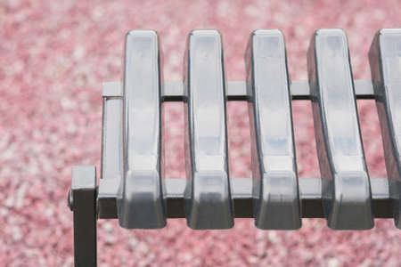Metal and plastic bench near the grave in the cemeteryの写真素材