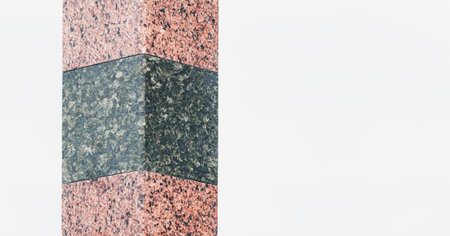 Fragment of a dark granite tombstone on the grave