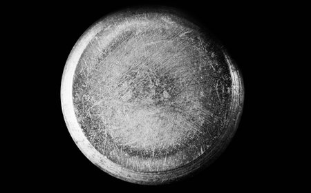 Enlarged image of a metal object in the form of a roller with scratches