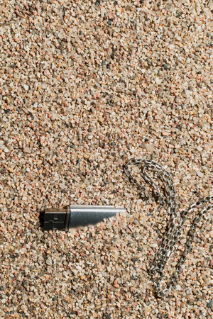 The silver flash drive with the information was lost in the sand