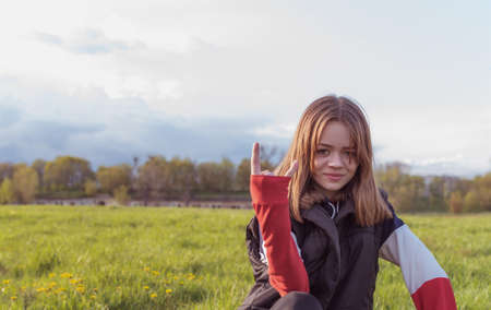 Portrait of a young girl at sunset, against the background of an old fortressの写真素材