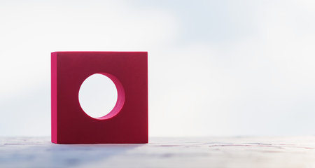Collage of geometric shapes made of foam rubber in different colors on the background of the window