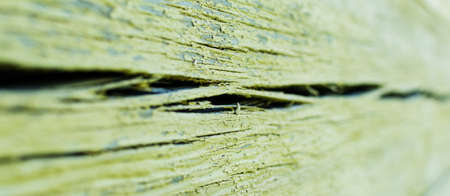 A fragment of the wall of an old log house made of timber with cracksの写真素材