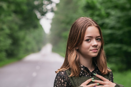 Portrait image of a young girl on a forest road
