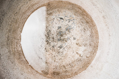 Water in a large metal container, a textural image of the agitation of the liquid