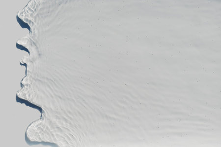 View of the pouring water with splashes on a light backgroundの写真素材