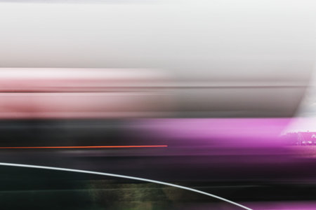 A blurry image of a car moving along a city streetの写真素材