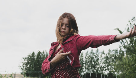 The image of a young girl against the background of a country evening landscape
