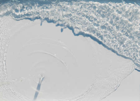 View of the pouring water with splashes on a light backgroundの写真素材