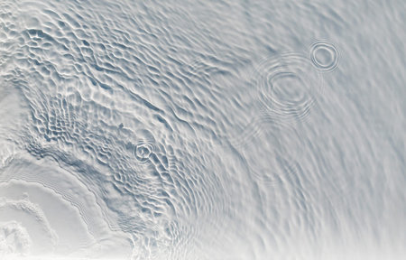 The bubbling and splashing of clear, transparent water on a light tray
