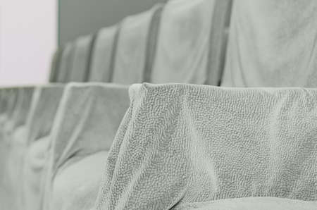 A row of old chairs covered with a clothの写真素材