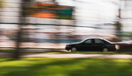 A blurry image of a car moving around the cityの写真素材