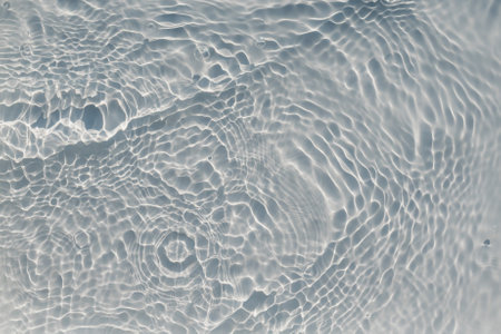 The bubbling and splashing of clear, transparent water on a light trayの写真素材