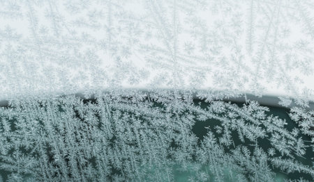Car glass covered with frozen frost with a variety of patterns