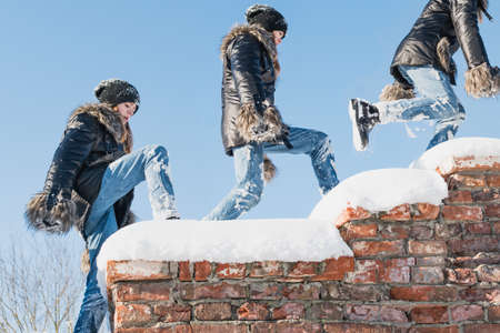 A young girl is playing in a snow-covered old fortress, on a sunny dayの写真素材