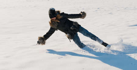 A young girl is playing in a snow-covered old fortress, on a sunny dayの写真素材