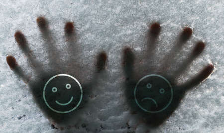 Human hands on the frozen glass with snow on the carの写真素材