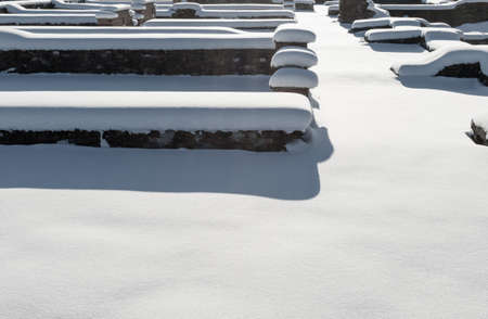 The ruins of a ruined brick fortress under the snow, on a sunny dayの写真素材