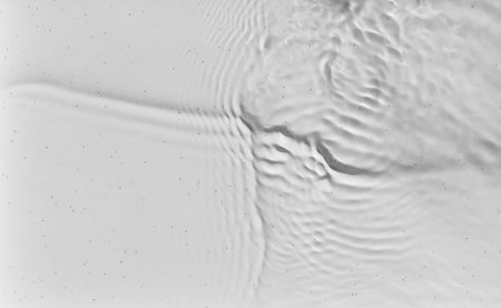The bubbling and splashing of clear, transparent water on a light tray