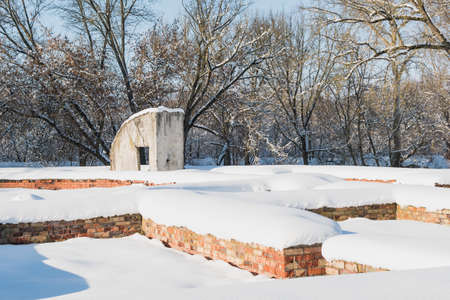 The ruins of a ruined brick fortress under the snow, on a sunny dayの写真素材