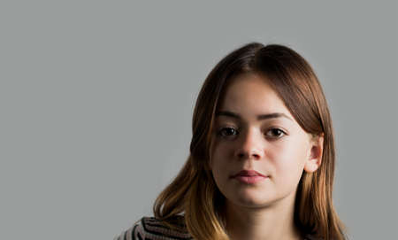 Portrait image of a young girl on a gray backgroundの写真素材