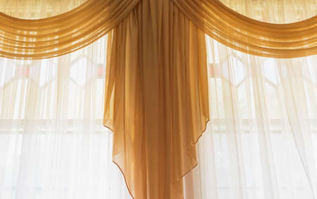 A fragment of the interior of an old building, windows with curtainsの写真素材