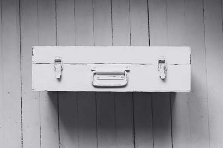 An old suitcase with a handle painted whiteの写真素材