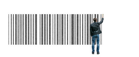 A young guy draws a barcode on a large posterの写真素材