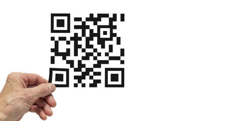 A worker removes a film with a qr code from a plastic surfaceの写真素材