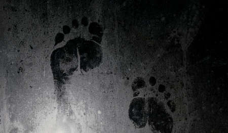 Footprint on fogged and frozen glassの写真素材