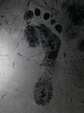 Footprint on fogged and frozen glassの写真素材