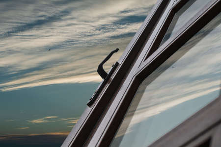 A fragment of a new plastic door with a handle covered with laminationの写真素材