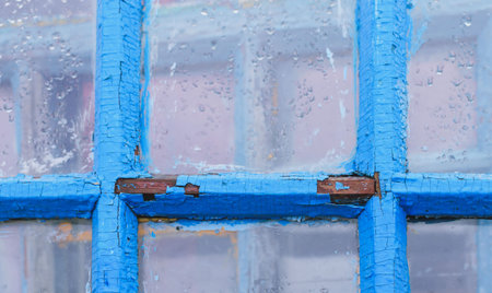A fragment of an old window frame with cracked paint