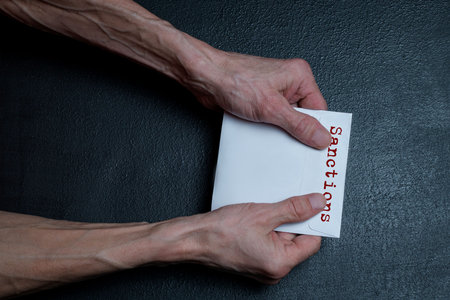 The man's hands hold a new CD with information