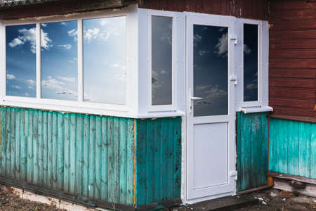 Plastic frame with windows and door for the veranda of a country houseの写真素材
