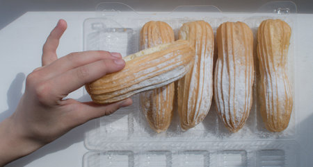 Type of eclairs with sugar in a plastic container