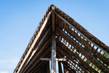 A fragment of the roof of an old barn destroyed by timeの写真素材