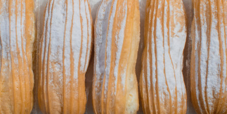 Type of eclairs with sugar in a plastic container