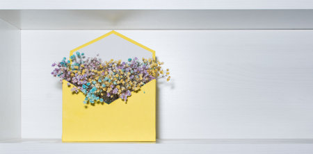 Decorative yellow box with flowers on the shelf
