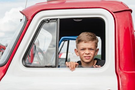 A little boy is playing near an old special equipmentの写真素材